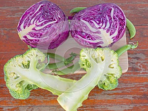 Vegetables, broccoli, Purple cabbage and peas on cutting boards on Wooden table .