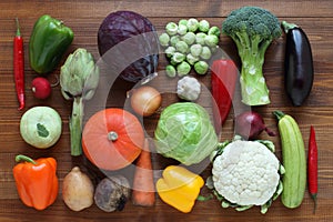 Vegetables on a brown wooden table. View from above. Closeup