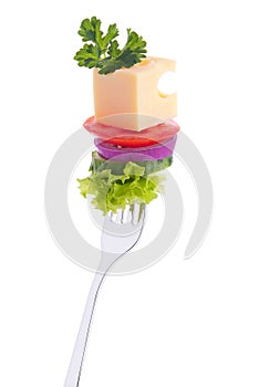 Vegetables, cheese, parsley on a fork.