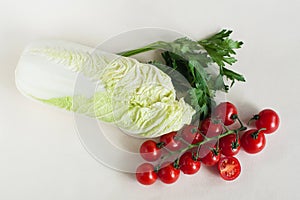 Vegetables cherry tomatoes with a twig, Peking cabbage and greens