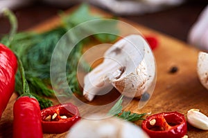 Vegetables on cutting board, plate with salt over white textured background, close-up, selective focus.