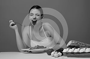 Vegetables diet. Happy smiling woman eating healthy food, dieting. Girl eating vegetable diet salad in studio. Vegan