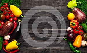 Vegetables of different colors on a dark textured background with an empty place for an inscription top view