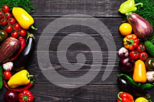 Vegetables of different colors on a dark textured background with an empty place for an inscription top view