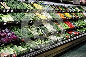 Vegetables displayed in a grocery store produce section.