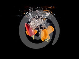 Vegetables falling in Water with black background