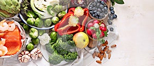 Vegetables, fish, berry on wooden background. Healthy food concept