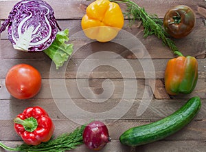 Vegetables flanking the wooden background photo