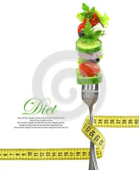 Vegetables on fork with measuring tape