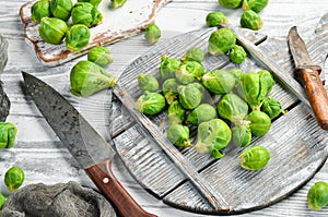 Vegetables. Fresh green brussels sprouts on a white wooden background. Rustic style.