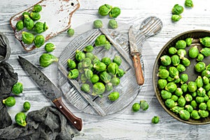 Vegetables. Fresh green brussels sprouts on a white wooden background. Rustic style.