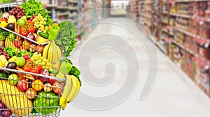 Vegetables and fruits over grocery store background. photo