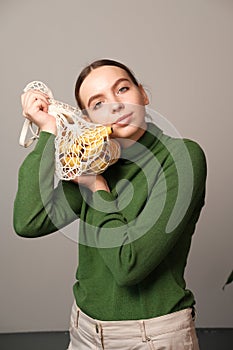Vegetables and fruits. shopping bag with bananas in the hands of a woman on a gray background.