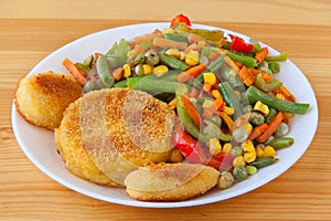 Vegetables gorse or tomatoes corn peas bell peppers carrots on plate