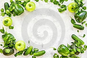 Vegetables for greeny smoothy with cucumber, pepper, apple, celeriac on stone background top view mock up