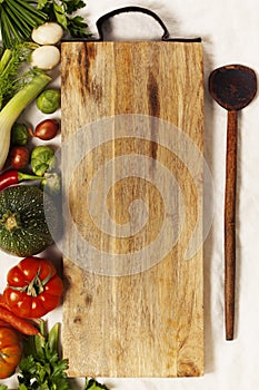 Vegetables, herbs, spices and empty cutting board