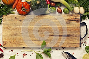 Vegetables, herbs, spices and empty cutting board