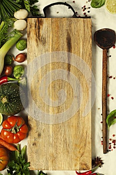 Vegetables, herbs, spices and empty cutting board