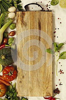 Vegetables, herbs, spices and empty cutting board