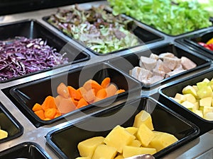 vegetables and meat in plastic trays in the market.