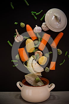 Vegetables in motion before cooking in soup