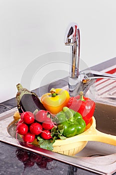 Vegetables near to steel faucet