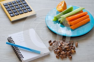 Vegetables and nuts on the scales. Calorie counting