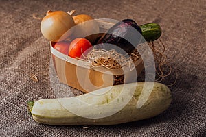 Vegetables, onions, eggplant, tomatoes and cucumbers in a basket. The concept of agriculture, healthy lifestyle, healthy eating