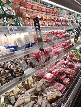 Vegetables packed inside plastic container and plastic wrap.