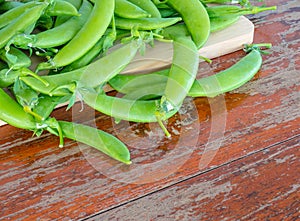 Vegetables, peas on cutting boards on Wooden table .