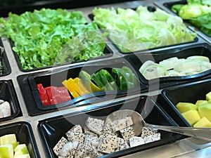 Vegetables in plastic box at the market. Healthy food concept.