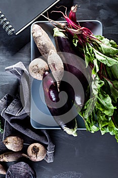 Vegetables on a plate with notebook from the top