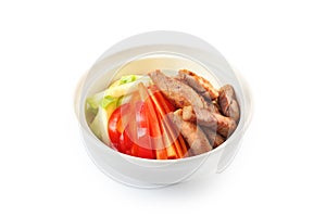 Vegetables with pork on a plate on a white background isolated