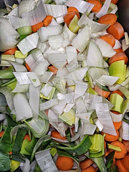 Vegetables prepared for further processing, chopped onion, carrot and leek, colorful vegetables, homemade food, home cooking