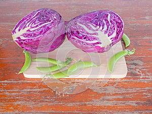 Vegetables, Purple cabbage and peas on cutting boards on Wooden table .