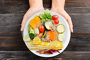 Vegetables salad holding by hand