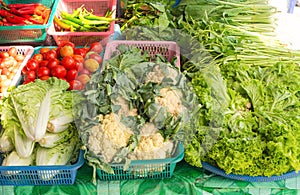 Vegetables on sale - cauliflower, lettuce, tomatoes, chile, spinach at Thai market