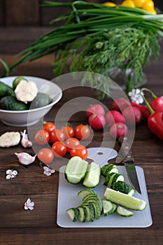 Vegetables sliced for a salad on a cutting board