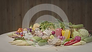 Vegetables and spices are laid out on the food preparation table.