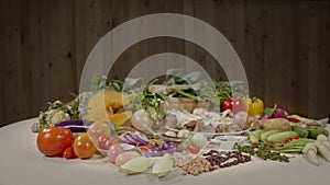 Vegetables and spices are laid out on the food preparation table.