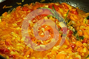 Vegetables and spices in pan closeup