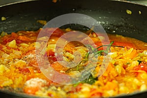 Vegetables and spices in pan closeup