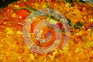Vegetables and spices in pan closeup