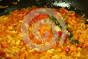 Vegetables and spices in pan closeup