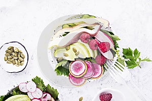 Vegetables summer fruit detox bowl. Vegetarian healthy food. Salads, lettuce leaves, avocado, raspberries, cucumber