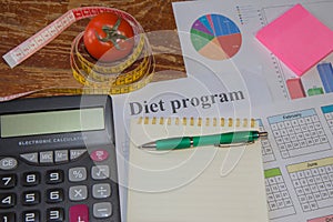 Vegetables, tomato. Measure tape, calculator, notepad and fresh tomato in the background. Healthy lifestyle diet