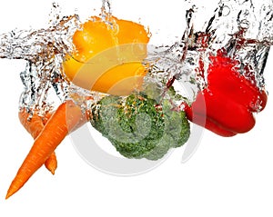 Vegetables in water splash. Isolated on white background