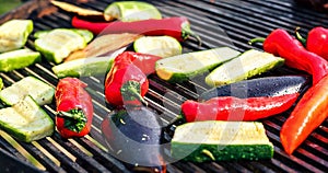 Vegetarian barbecue with zucchini, red pepper, eggplant, grilled over charcoal. Vegetables on the grill over low heat