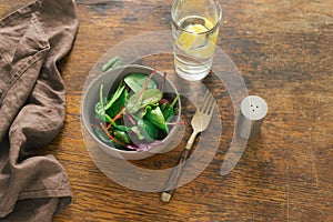 Vegetarian biodynamic food. Bowl salad spinach, beet leaves, water, lemon photo