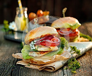 Vegetarian burger with grilled halloumi cheese, fresh lettuce, tomato, cucumber and onion with the addition of yoghurt mint sauce